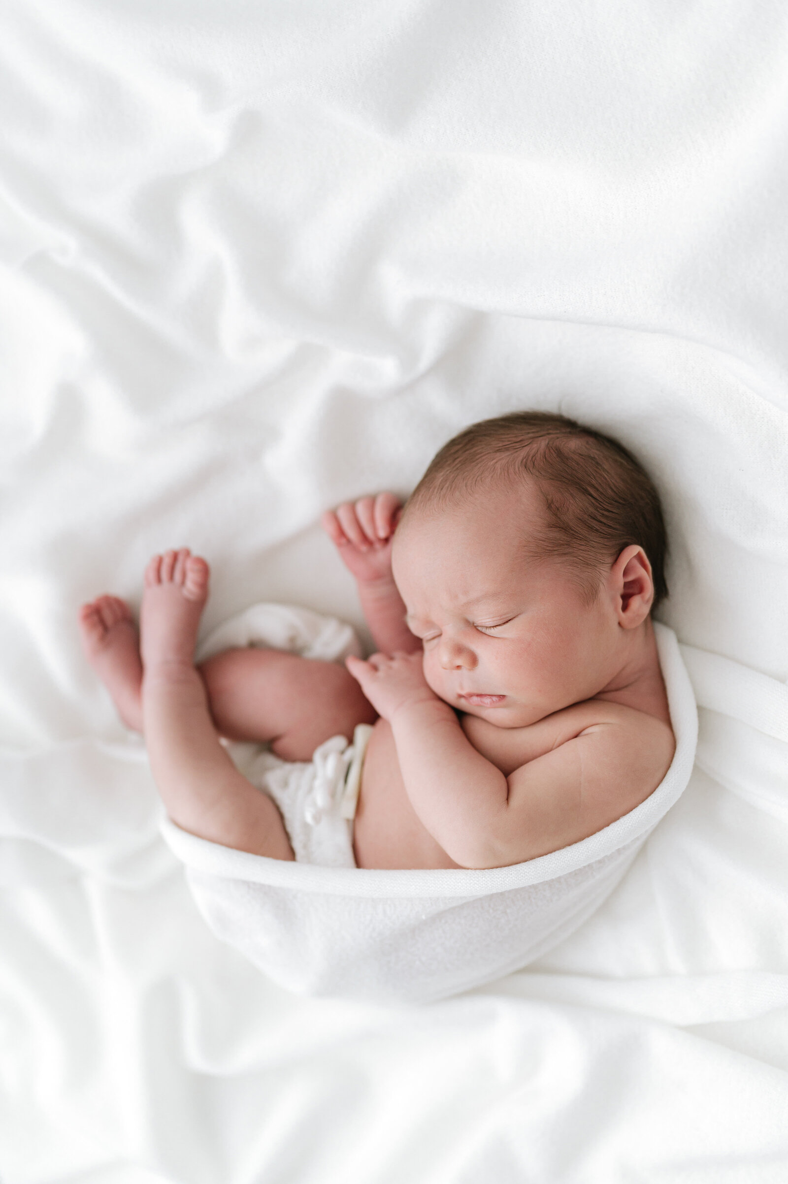 Artistic Bristol newborn photography of a baby on a white blanket