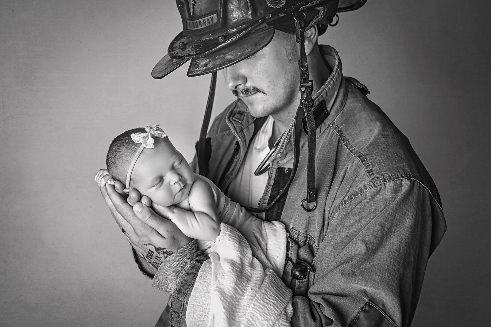 fire fighter holding a newborn oklahoma