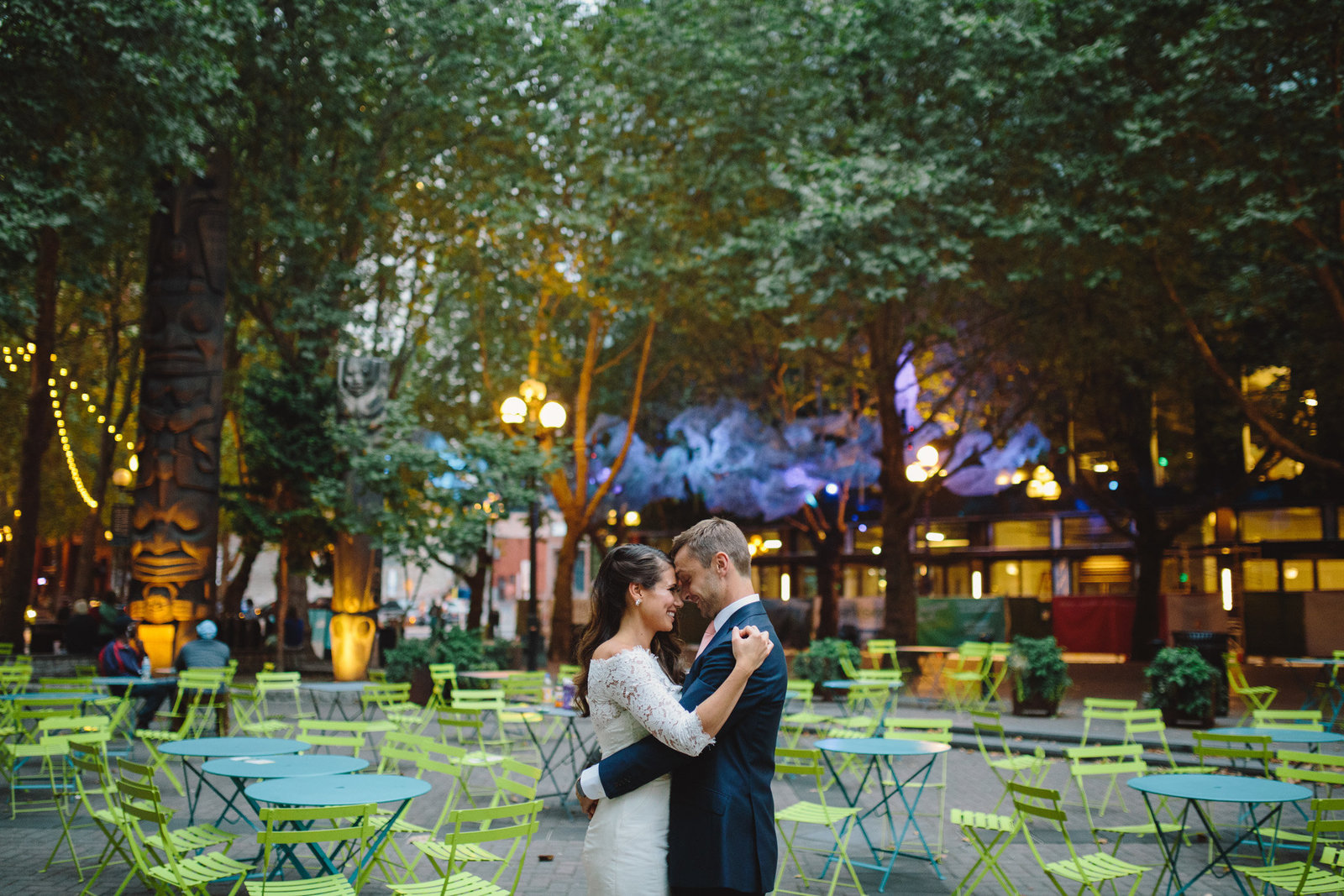 Bride and groom touching foreheads in Occidental Park