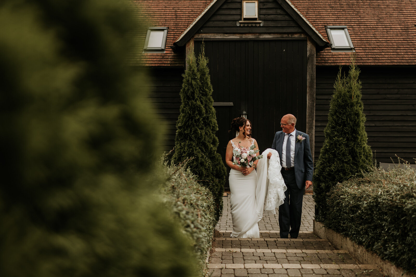 Bride and Dad walking and laughing