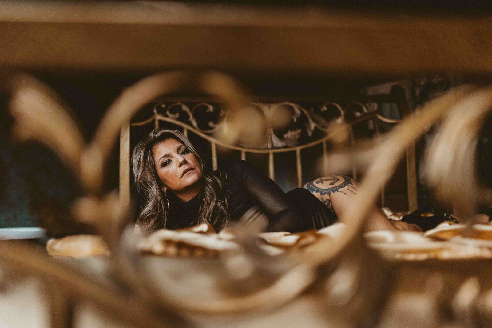 woman laying on the golden bed setup 