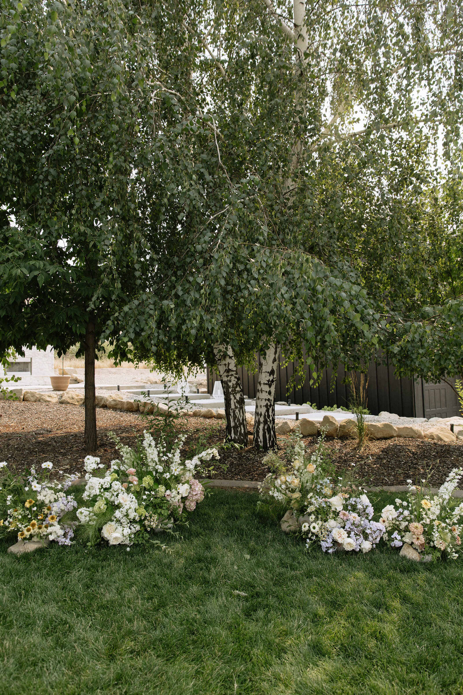 Large oak tree with wildflower details for outdoor ceremony at Bissel Creek wedding venue in Emmett, Idaho
