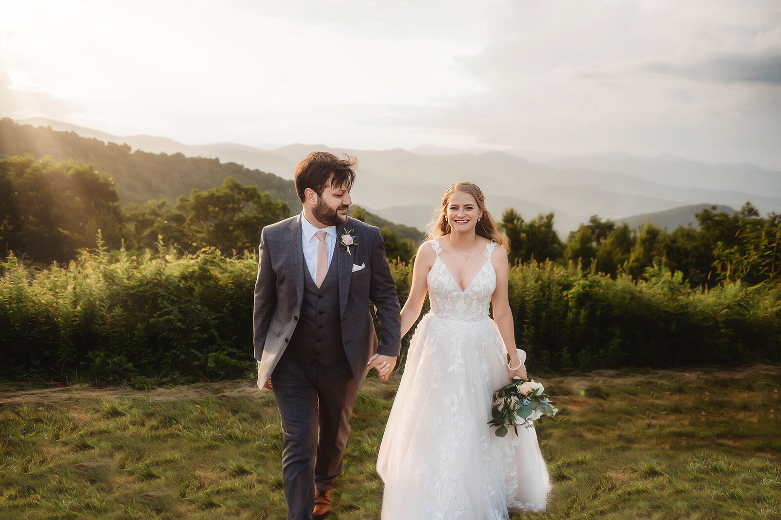 Bride and Groom walk hand in hand during their Elopement on the Blue Ridge Parkway in Asheville, NC.
