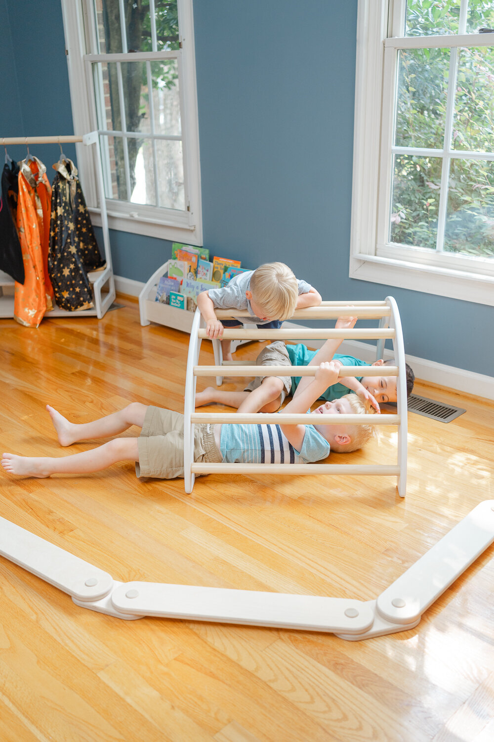 montessori toys with boys playing under it during product photo in Vienna,VA