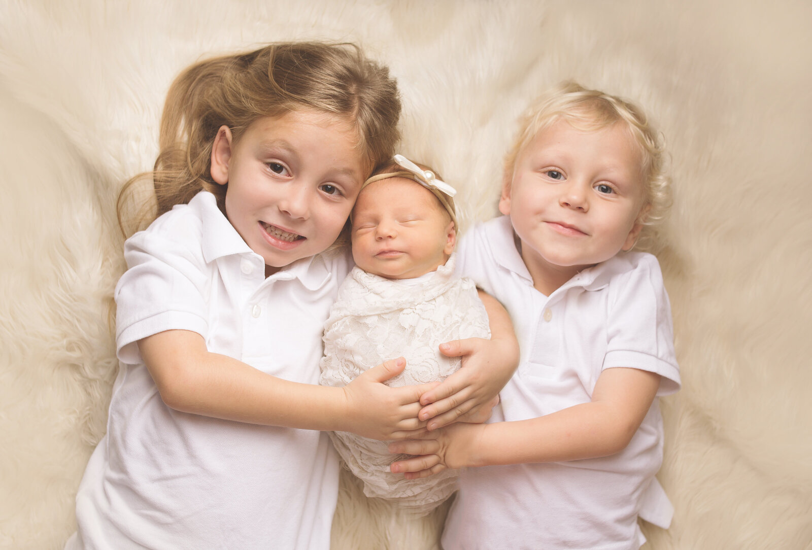Brothers, holding newborn baby, during newborn photoshoot with Nashville, TN photographer