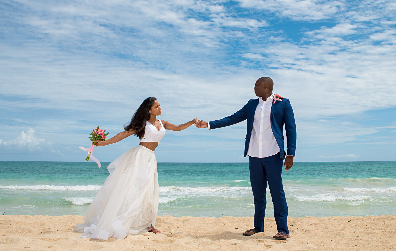Wedding couple dancing on the beach in Waikiki 