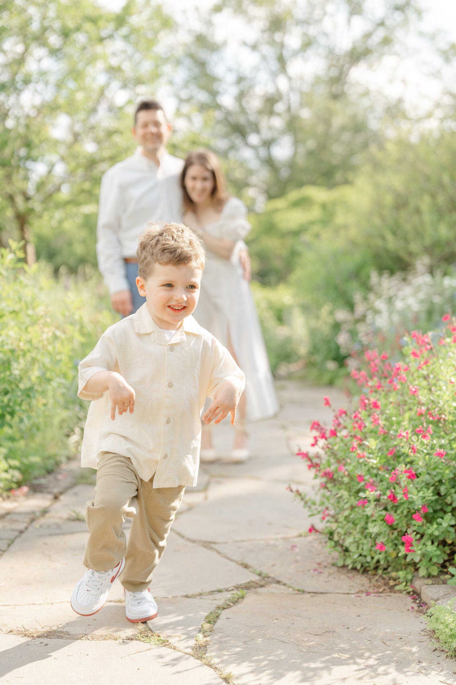 boy running away from parents during family session in Fairfax County, Virginia