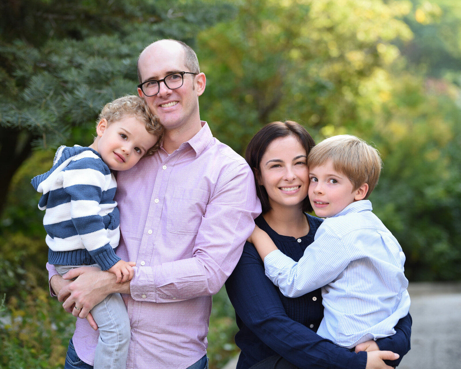 Parents holding young sons in arms for family portrait