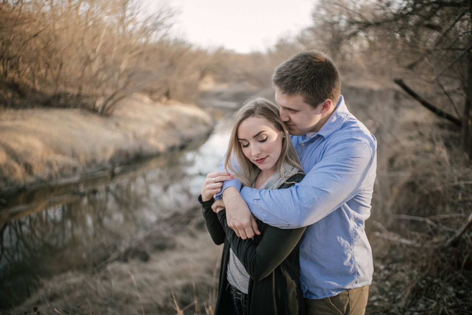 couple in romantic pose by creek
