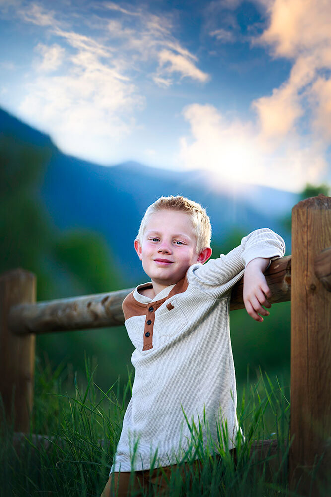 cute-young-boy-smiling-grining-relaxed-natural-smile-outdoors-big-open-colorado-cumulus-clouds-sky-all-natural-boy-great-outddors