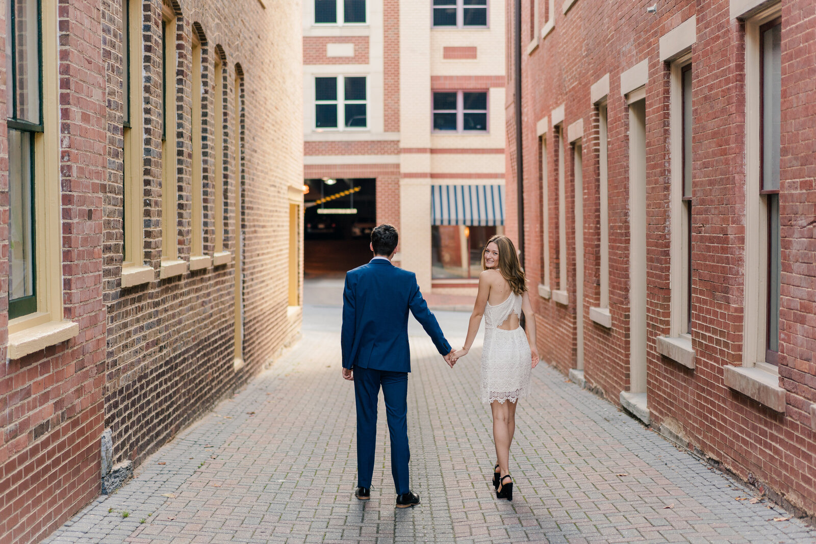 Bride and groom walk away from the Staunton courthouse hand-in-hand after their elopement ceremony