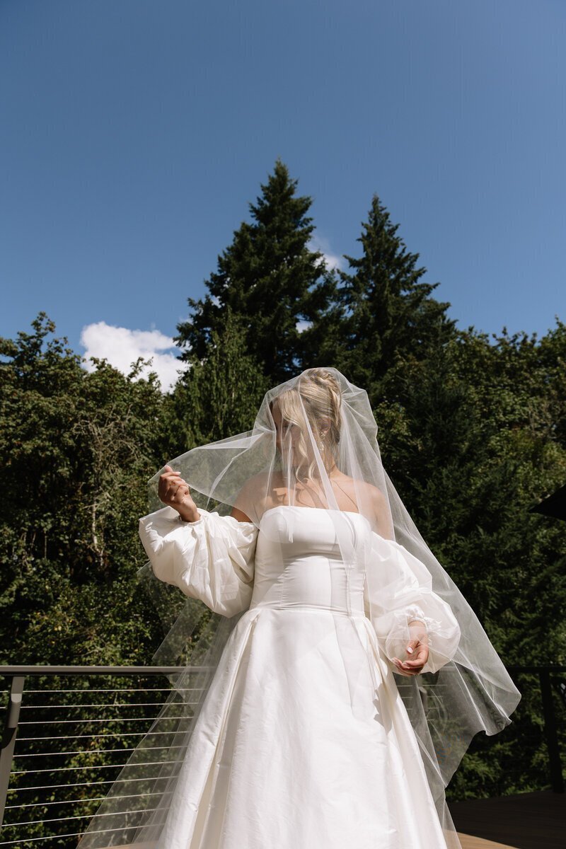 Bride with veil draping over face taken by washington elopement photographers