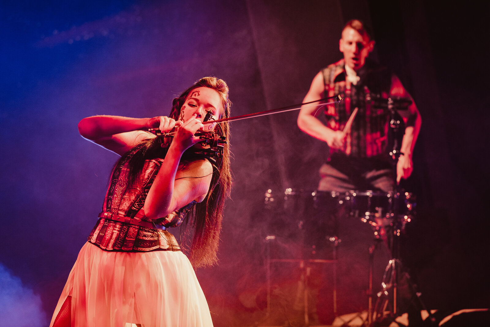 Violinist and drummer performing