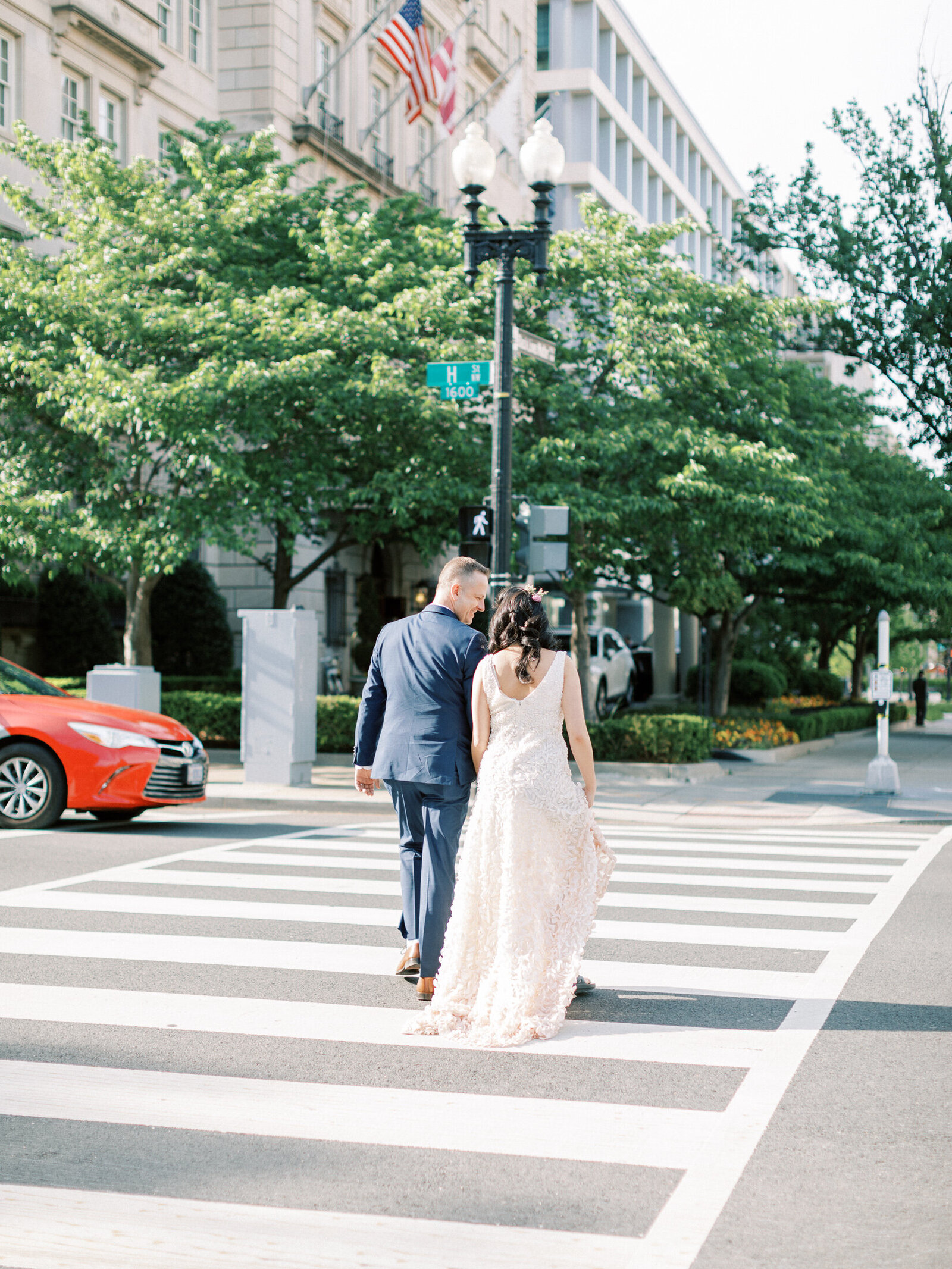 Bride and groom cross the street from the White House