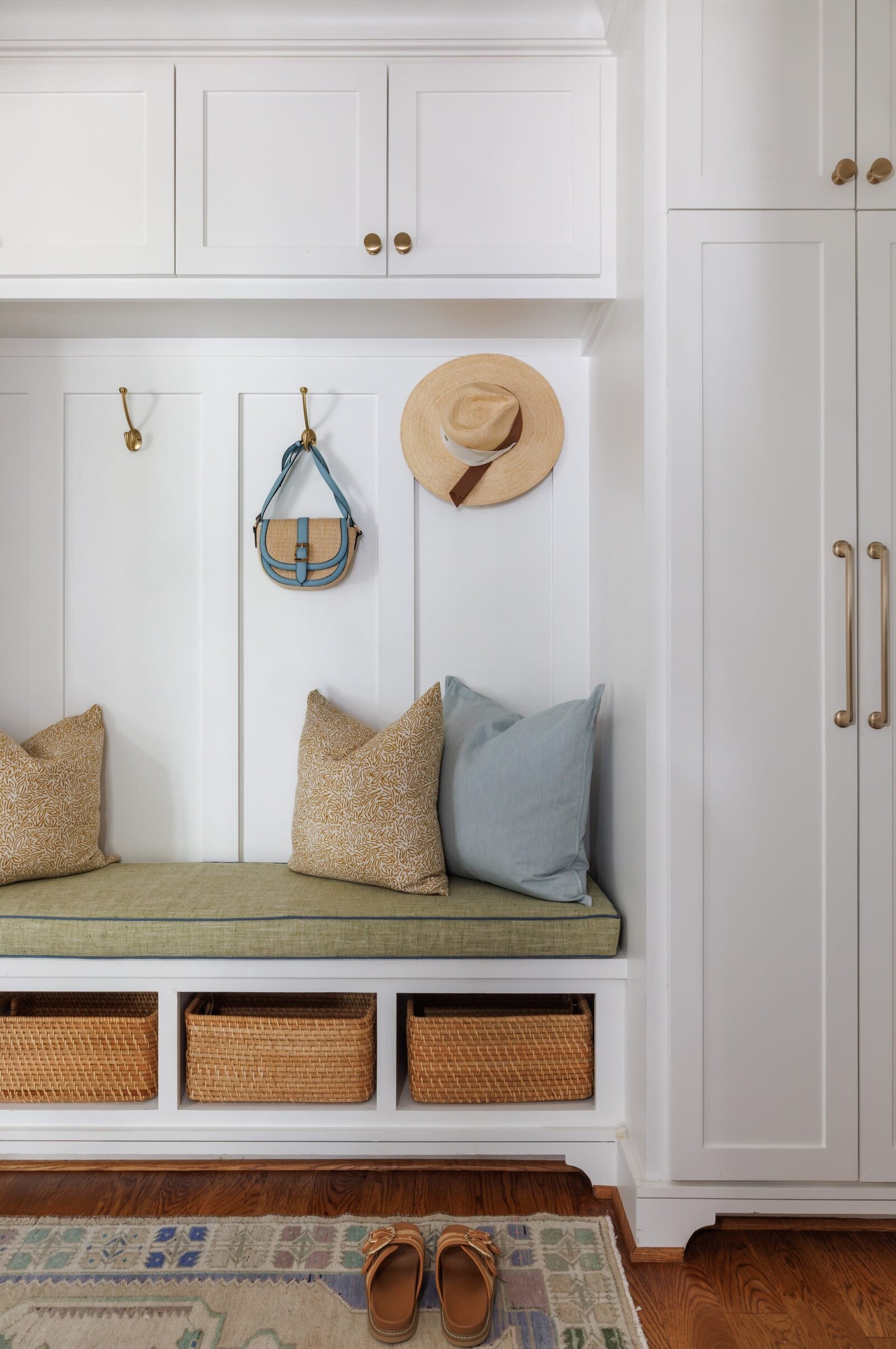 vision and hammer interior design entryway nook with white cabinets and wooden storage baskets