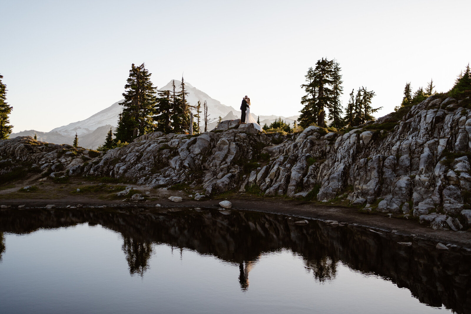 an eloping couple stands on a ridge in front of mount baker during their north cascades elopements