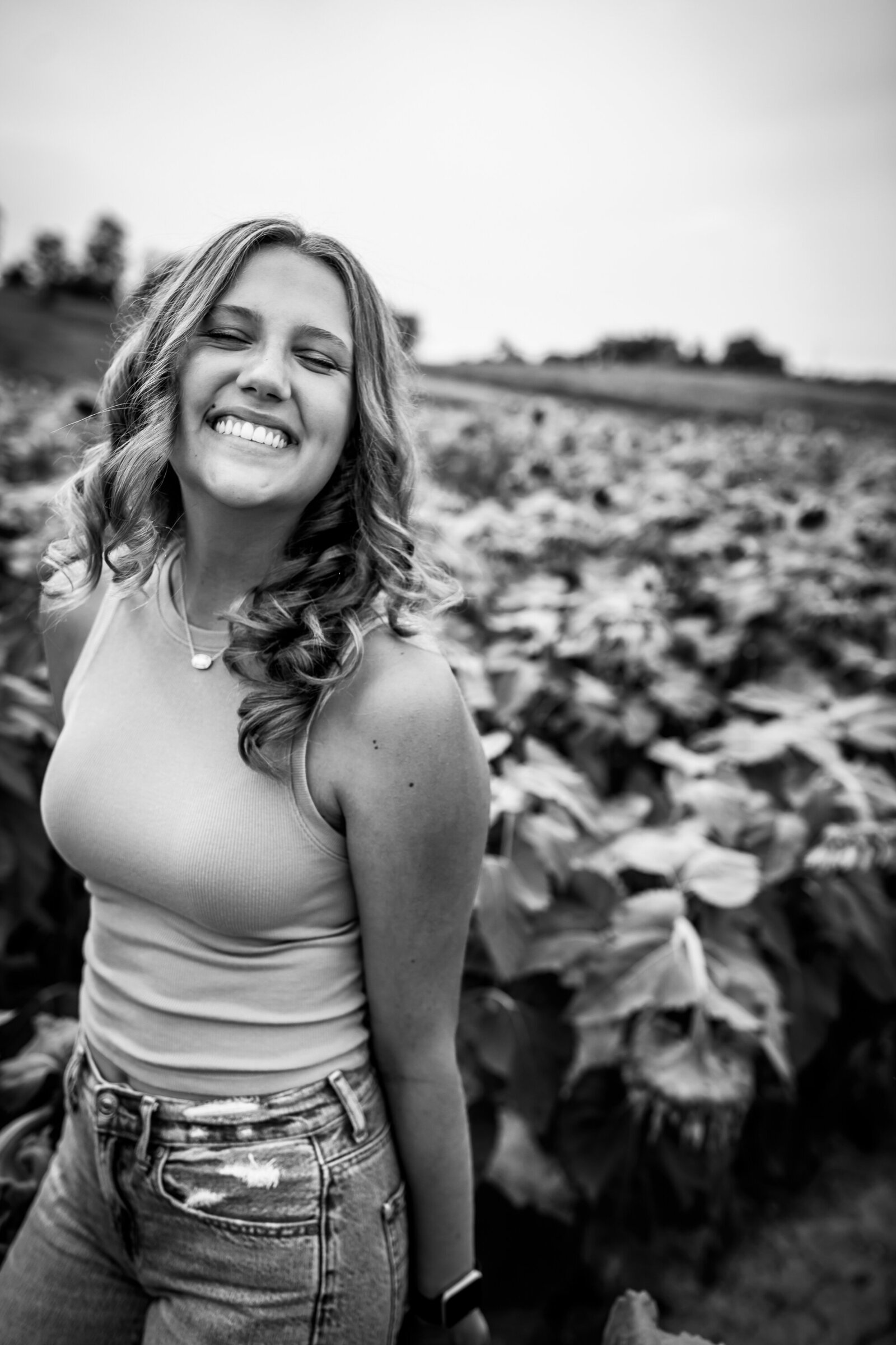 A striking black-and-white image of a laughing girl with curly hair in a field South of Pittsburgh.