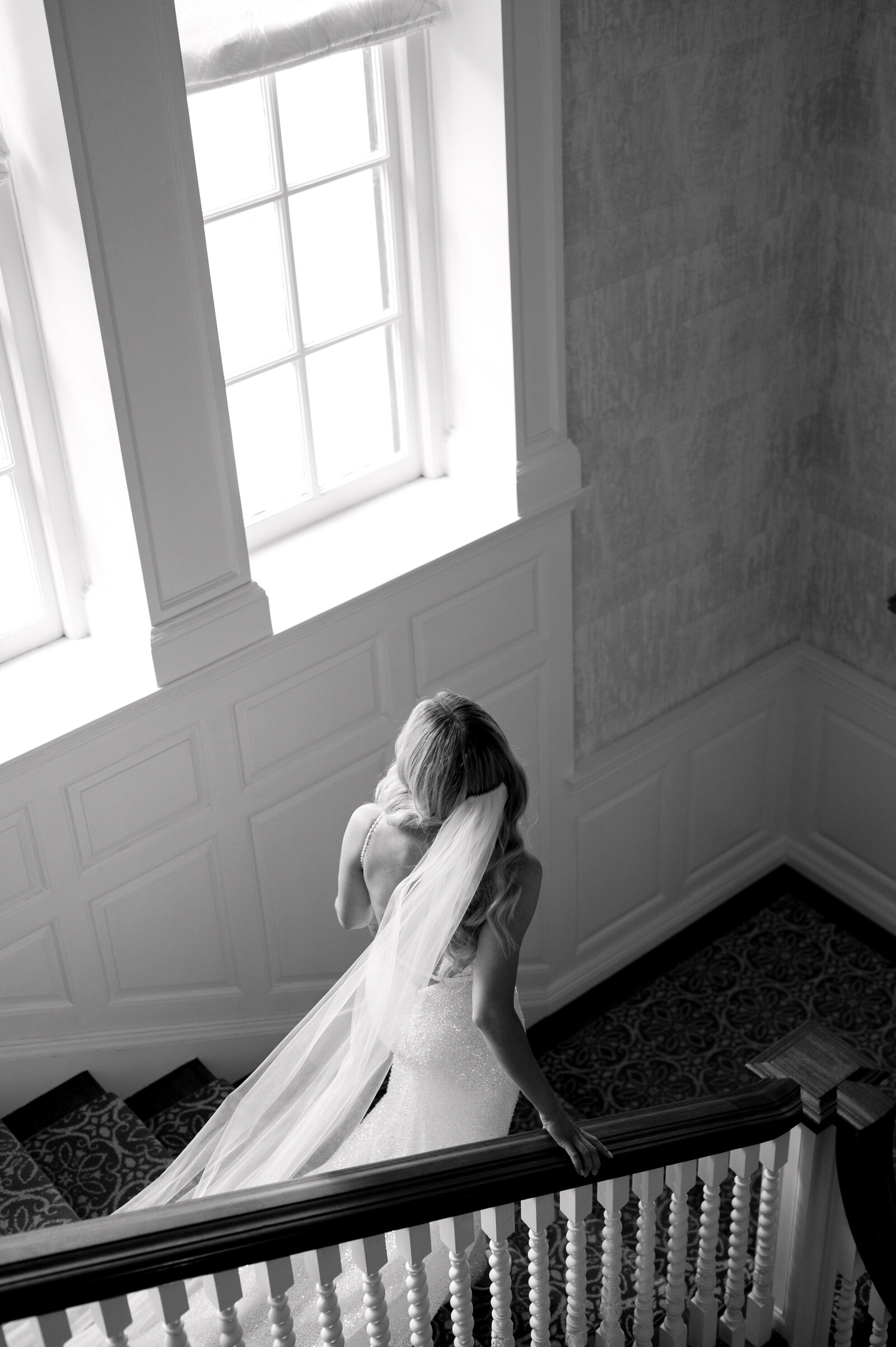 Editorial Bride Portrait walking down staircase at Graydon Hall Manor Toronto Wedding | Jacqueline James Photography