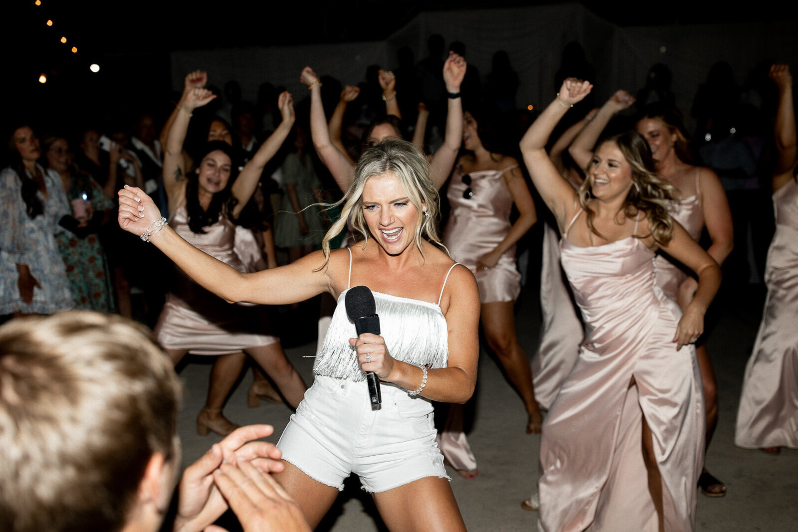 Eastern Iowa bride and bridesmaid doing a dance for the groom