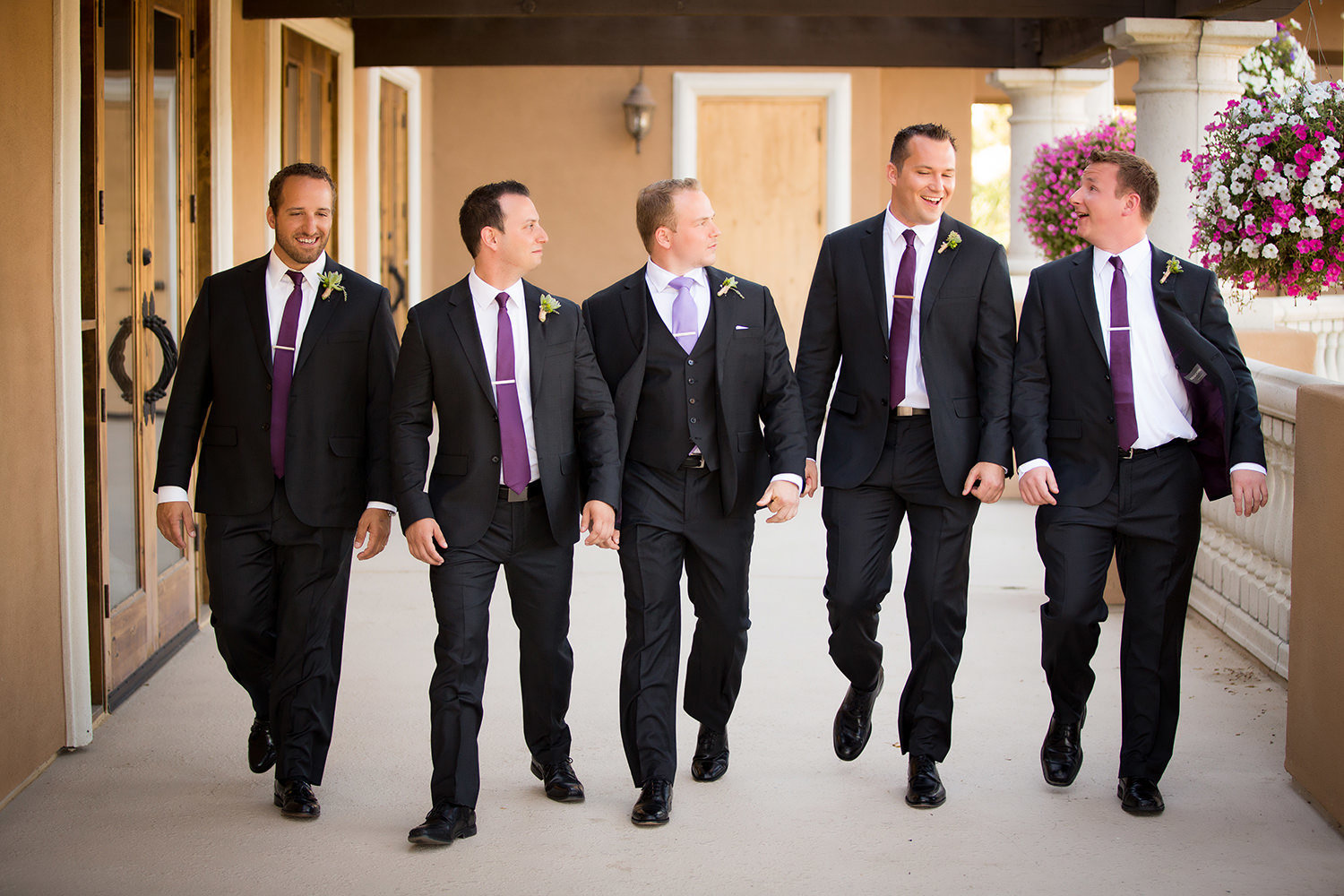 groomsmaid walking with purple ties