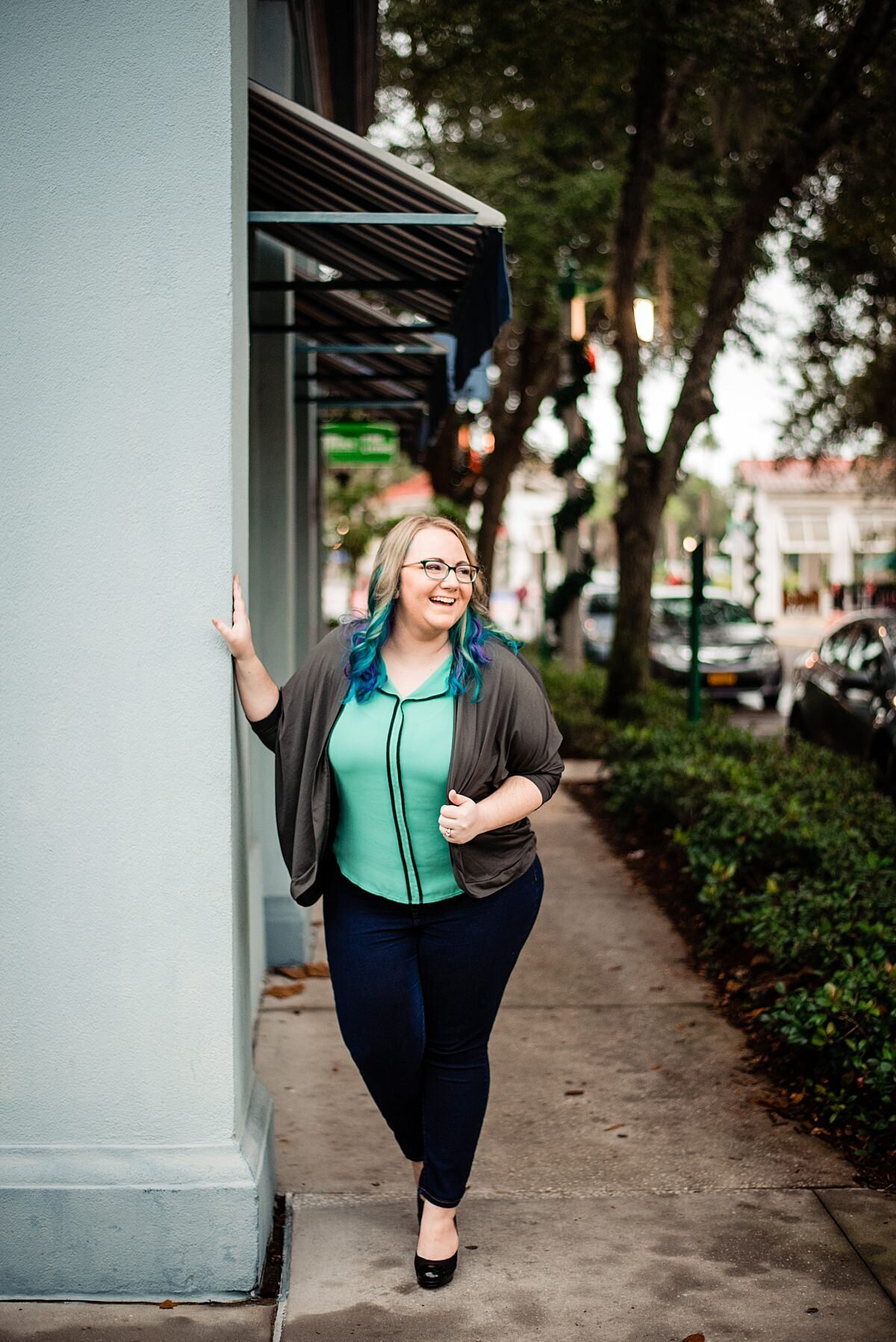 Mahlia wearing mint with teal curled hair in charming downtown Orlando village