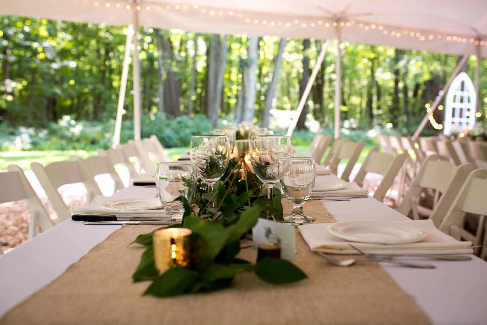 Harvest Table setting with greenery and candles at wedding reception The Clearing venue near London Ontario.