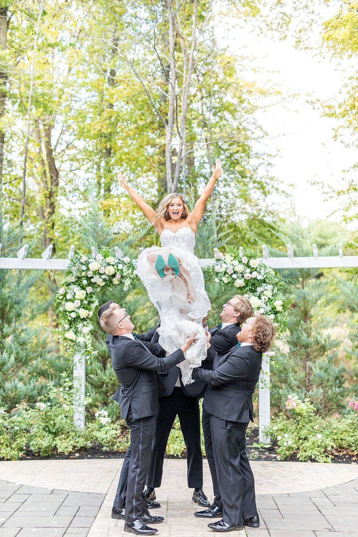 Groomsmen throwing bride in Essence of Australia wedding dress by Sherr Weddings based in Carlsbad, California.