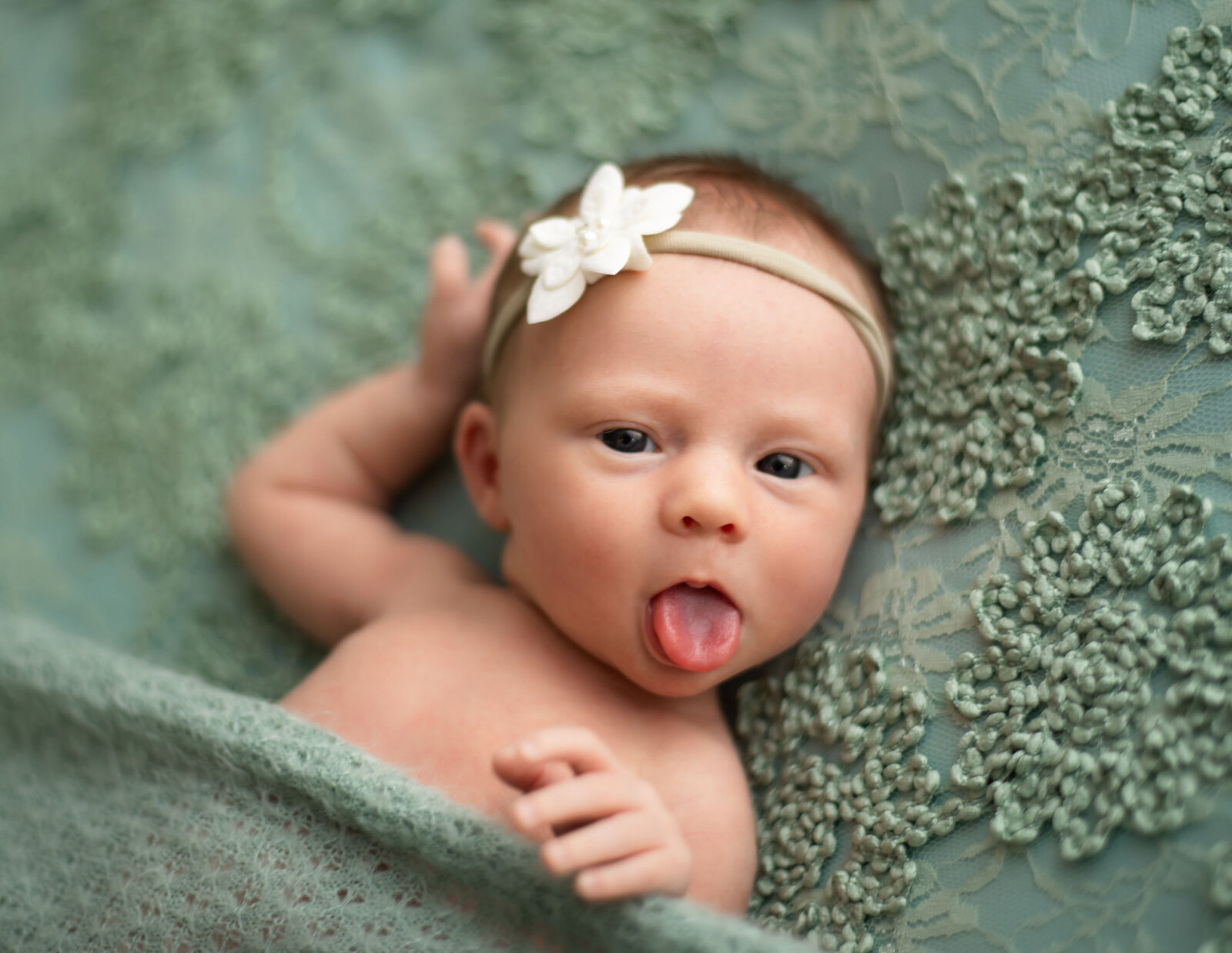 newborn sticking tongue out