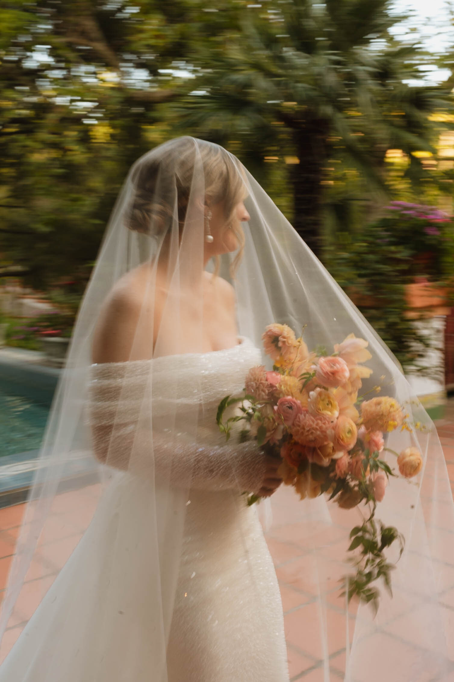 a bride and groom portrait by the ocean 