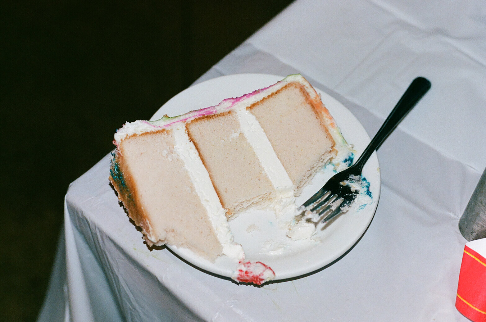 Three-tier vanilla wedding cake documentary style photograph from wedding reception | Sush Digital Media
