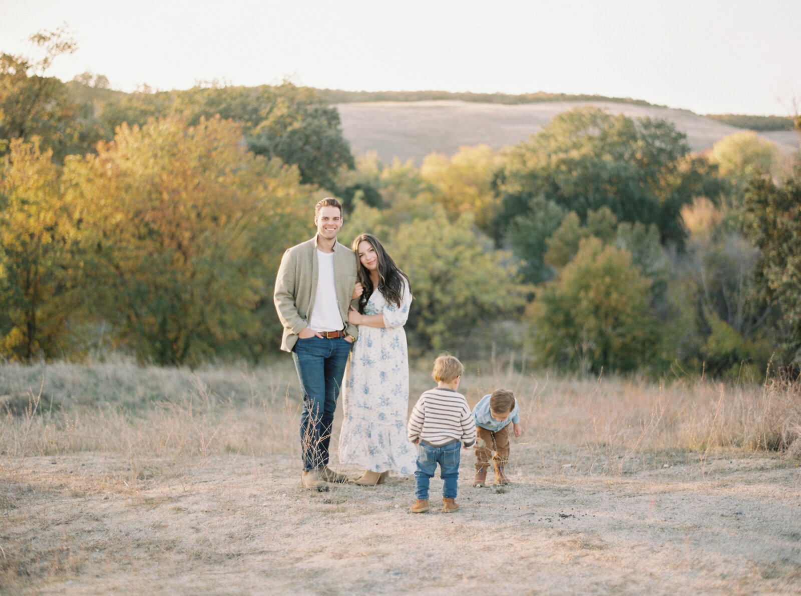 young family of four outside