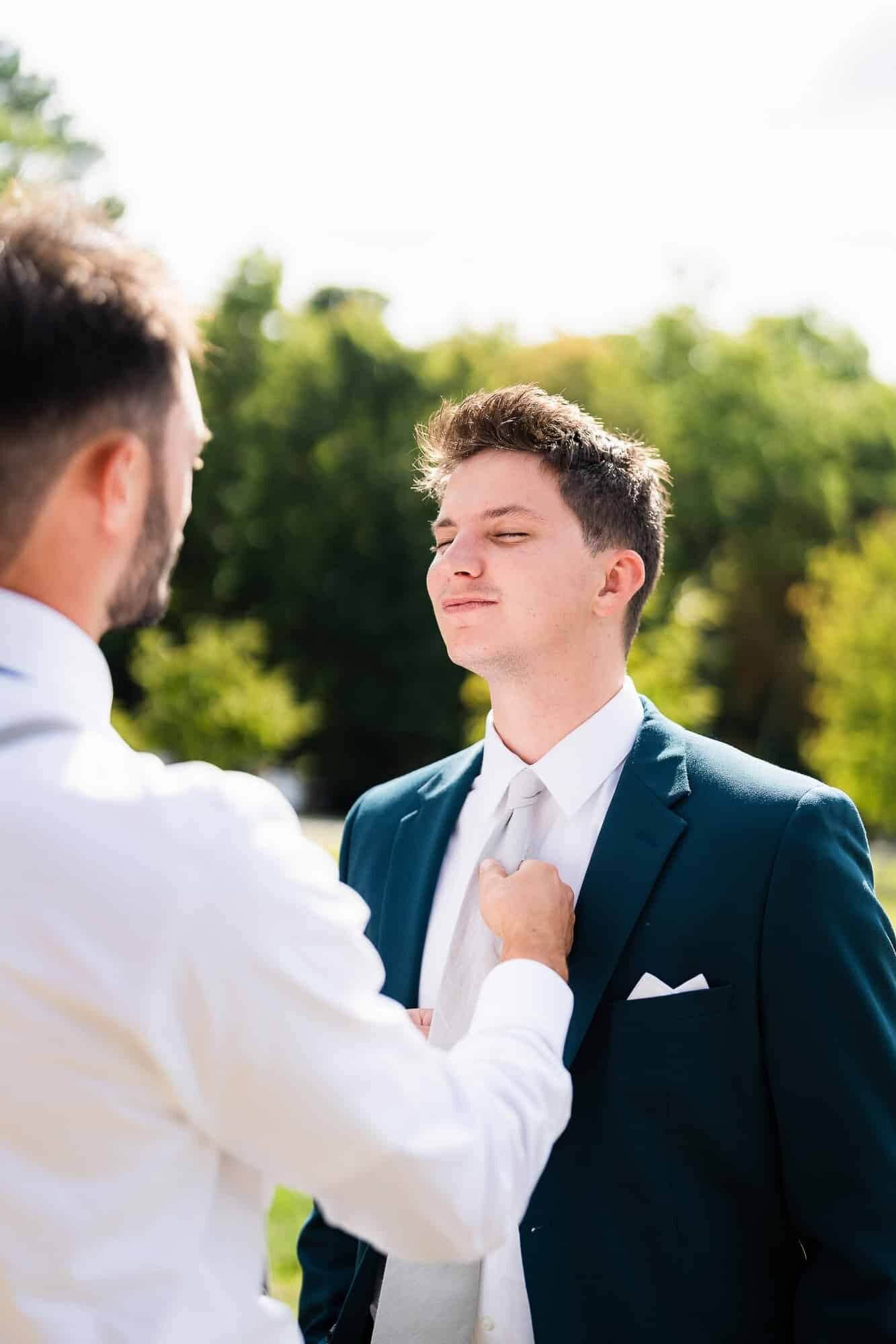 best man straightening the grooms tie North GA vineyard wedding 