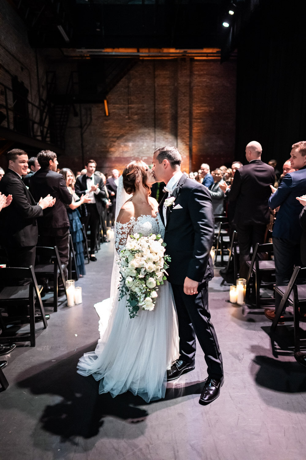 Bride and groom kiss at end of Civic Theatre wedding ceremony