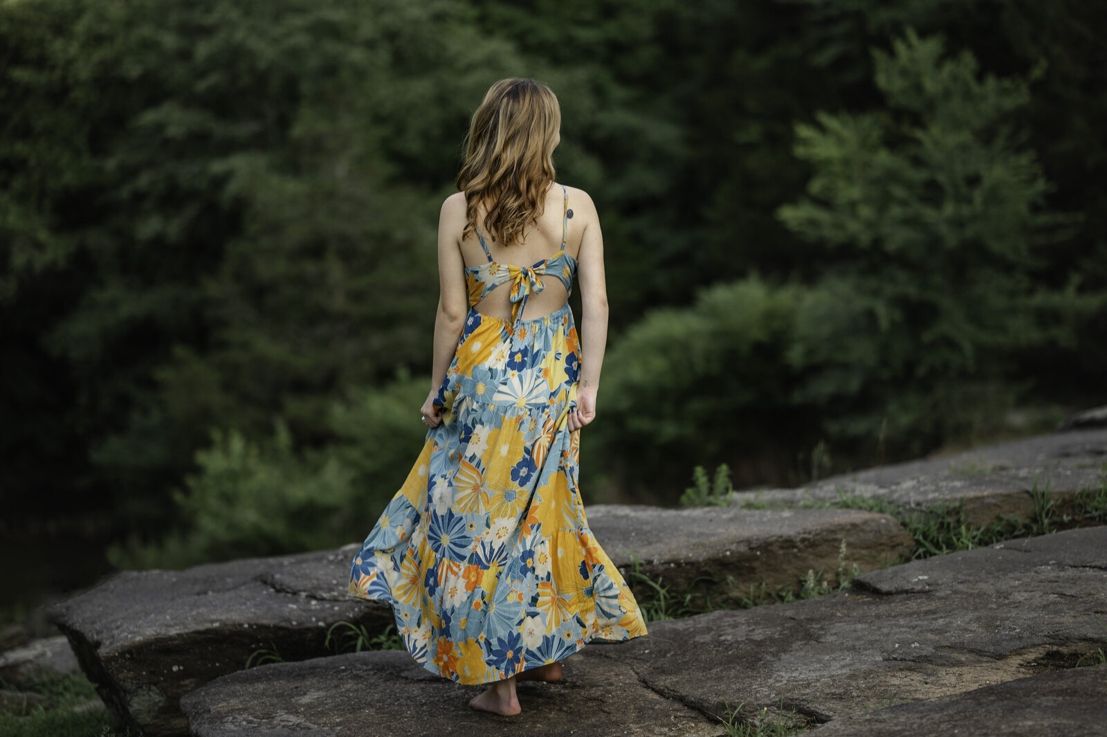 Girl twirls in her long dress during her senior photos at Sells Mill Park