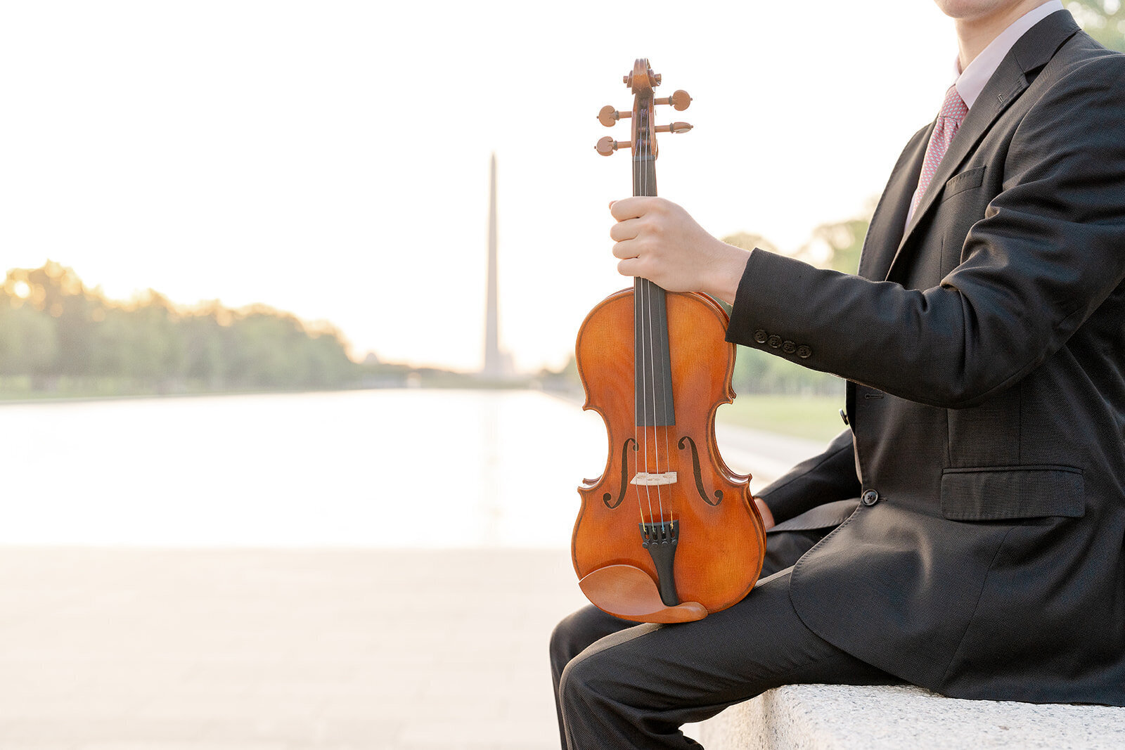 boy holding violin during Washington, DC senior photography