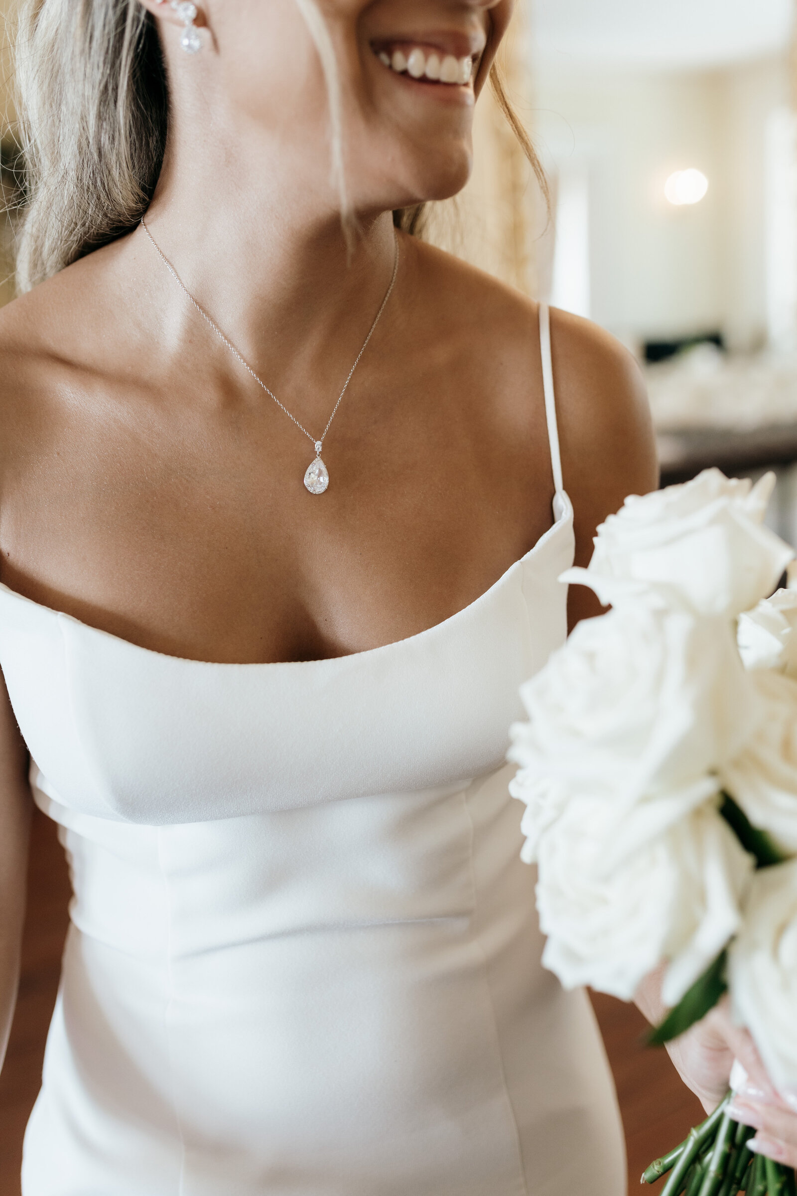 A close up of the bride before her wedding ceremony holding her white bouquet | Emma LeeAnn Photography