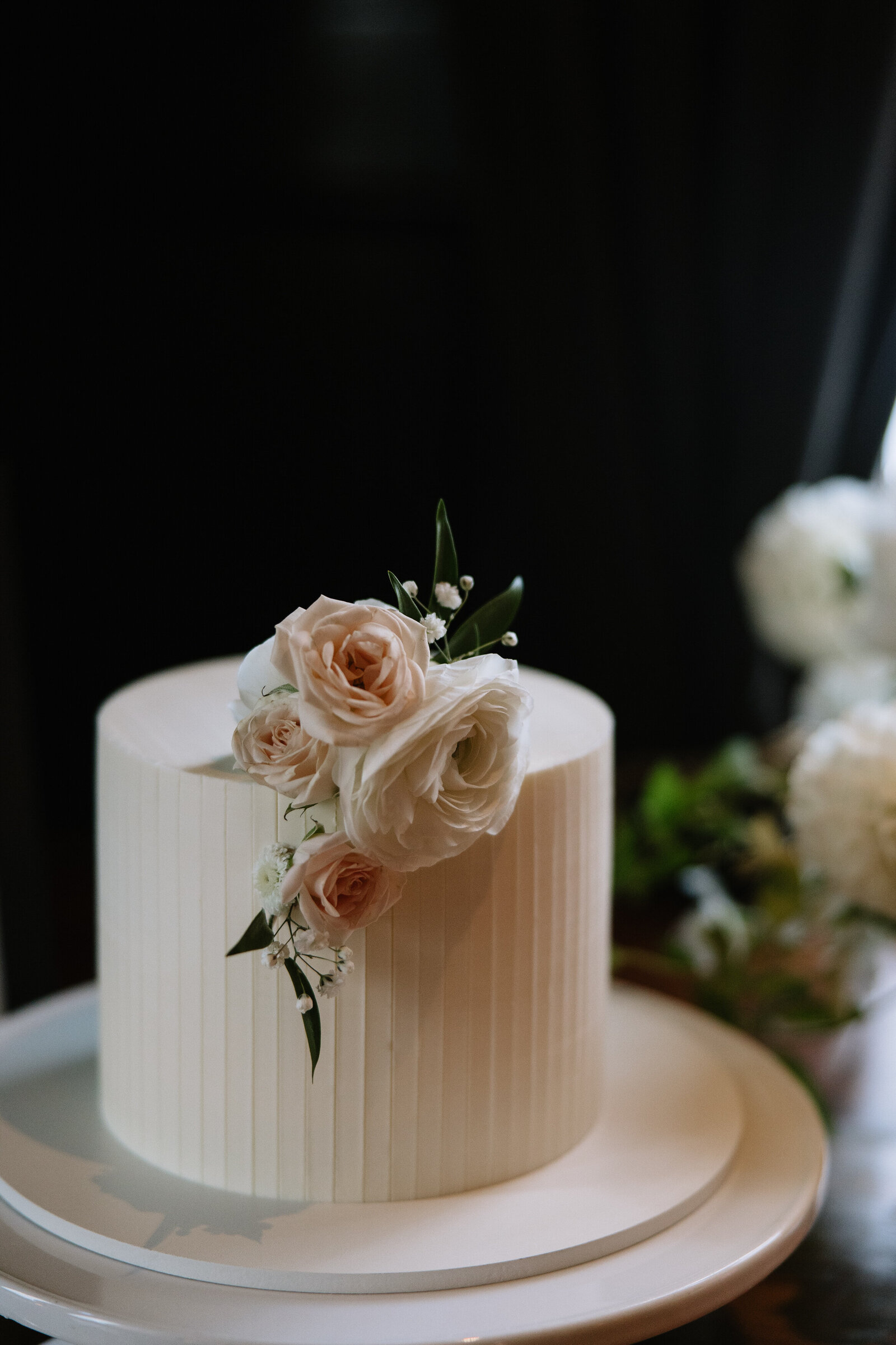Small wedding cake with florals at Wayfare Tavern by NorCal wedding photographer, Erica Rochelle