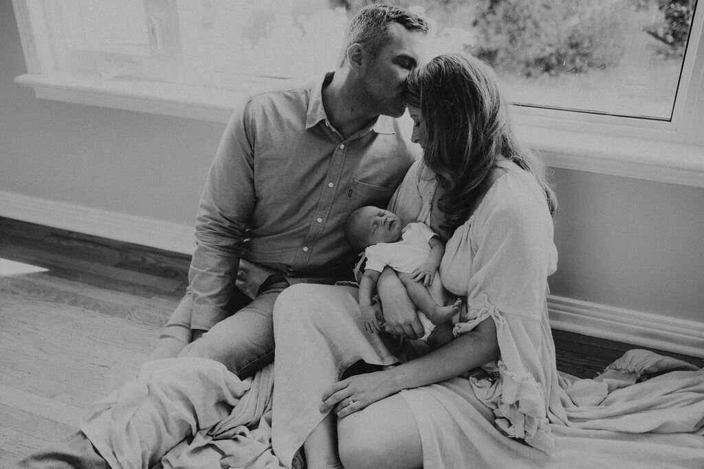 Dad kissing mom's forehead at home