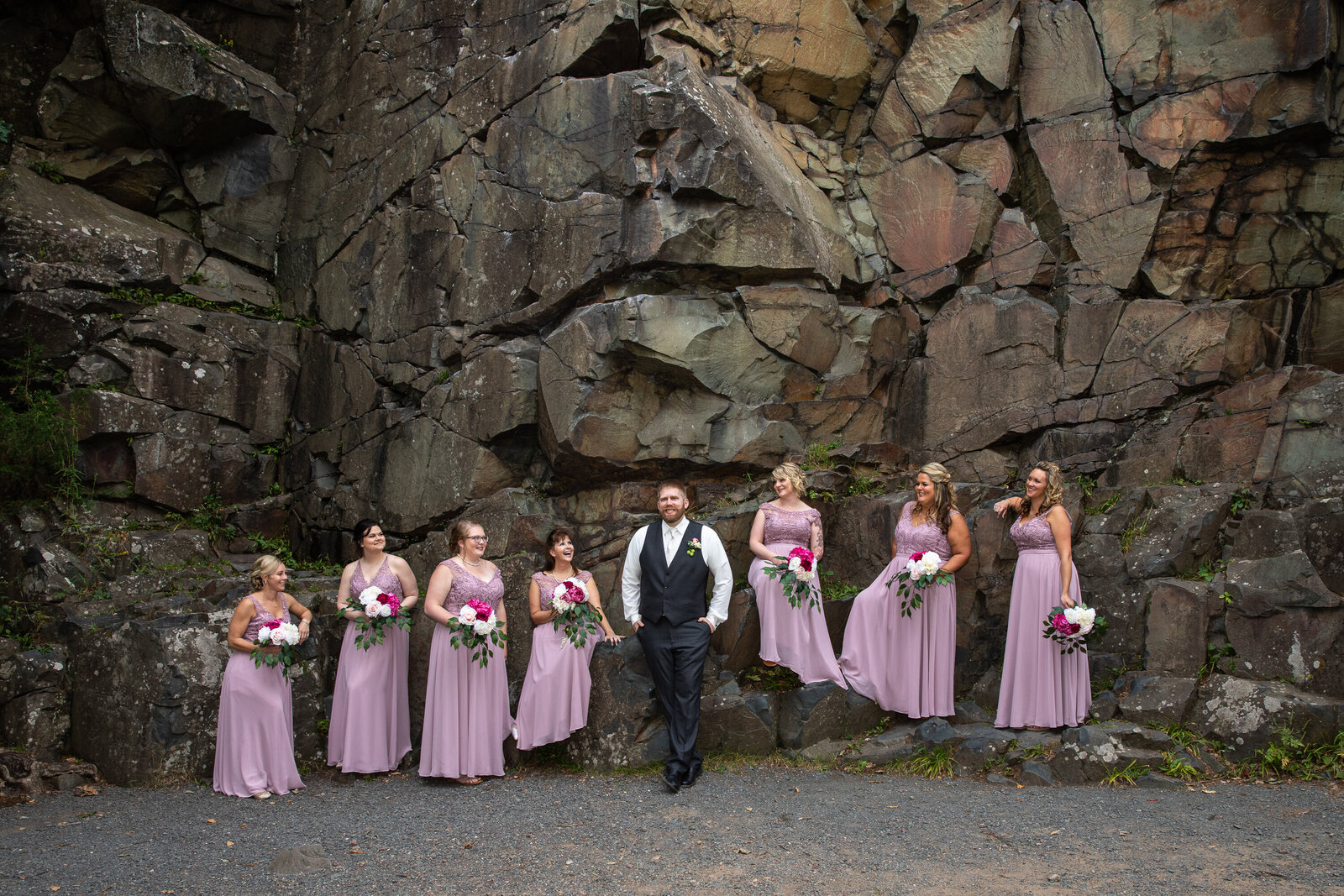 Groom with Bridal party by rock wall in Taylor's Falls