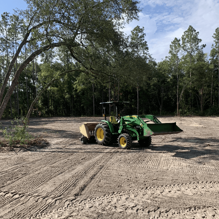 Photo of equipment and a completed land clearing project.