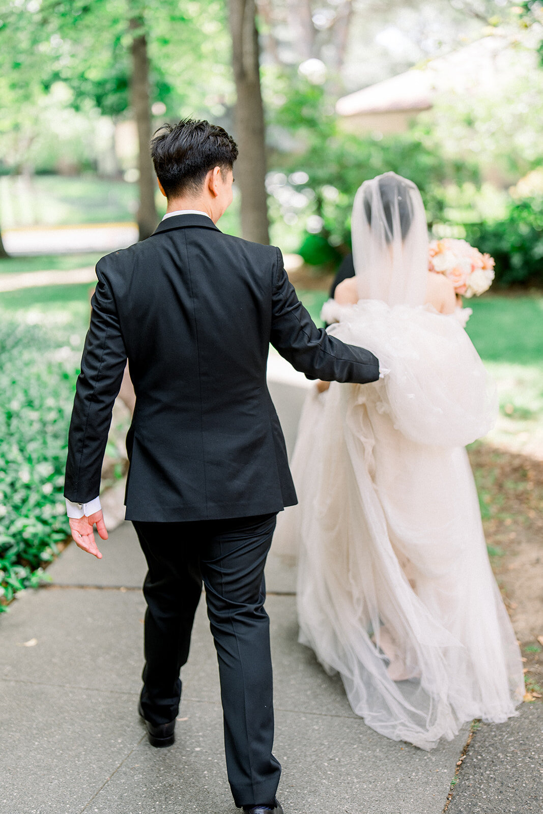 The newlyweds walk hand in hand through the lush gardens of Filoli, capturing the joy and romance of their wedding reception in Woodside, California.