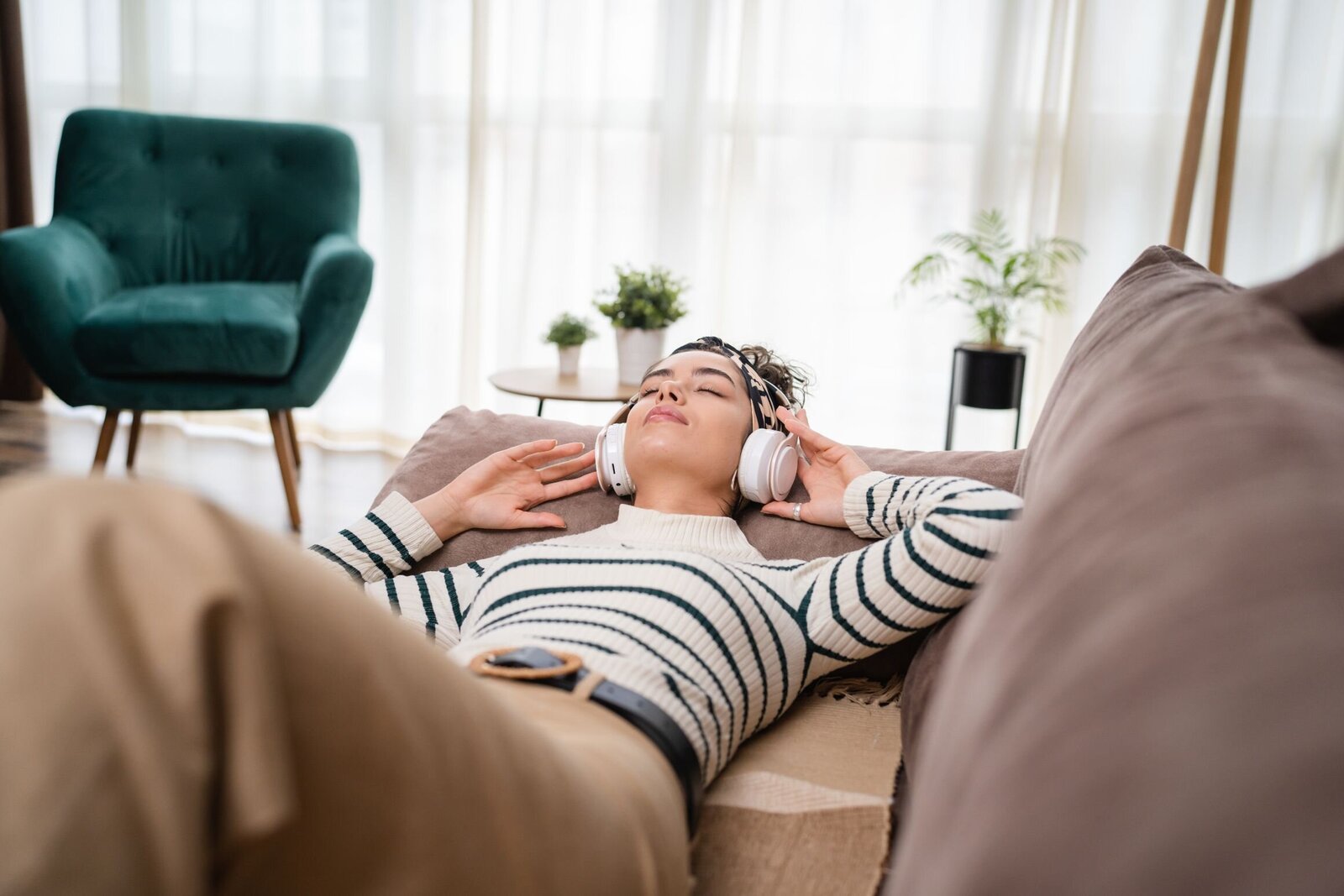 woman enjoying a Rapid Transformational Therapy Online session laying on a couch