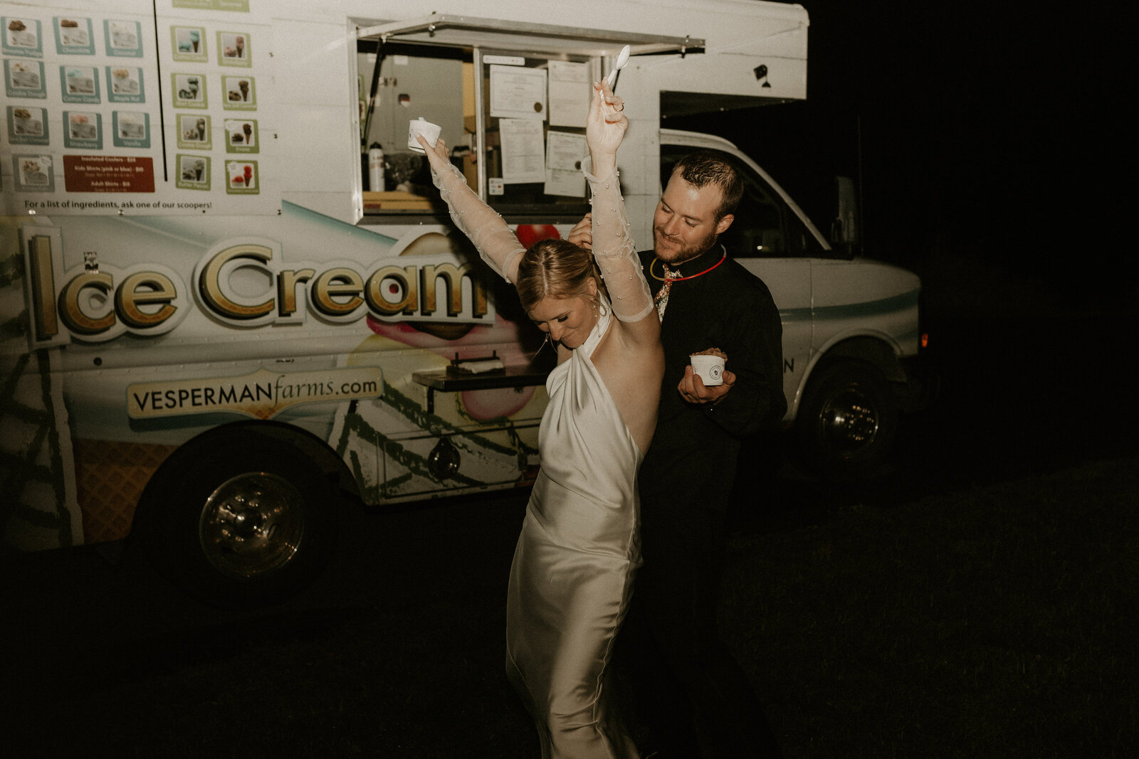 bride and groom dancing and eating ice cream in front of ice cream truck at Wisconsin wedding venue