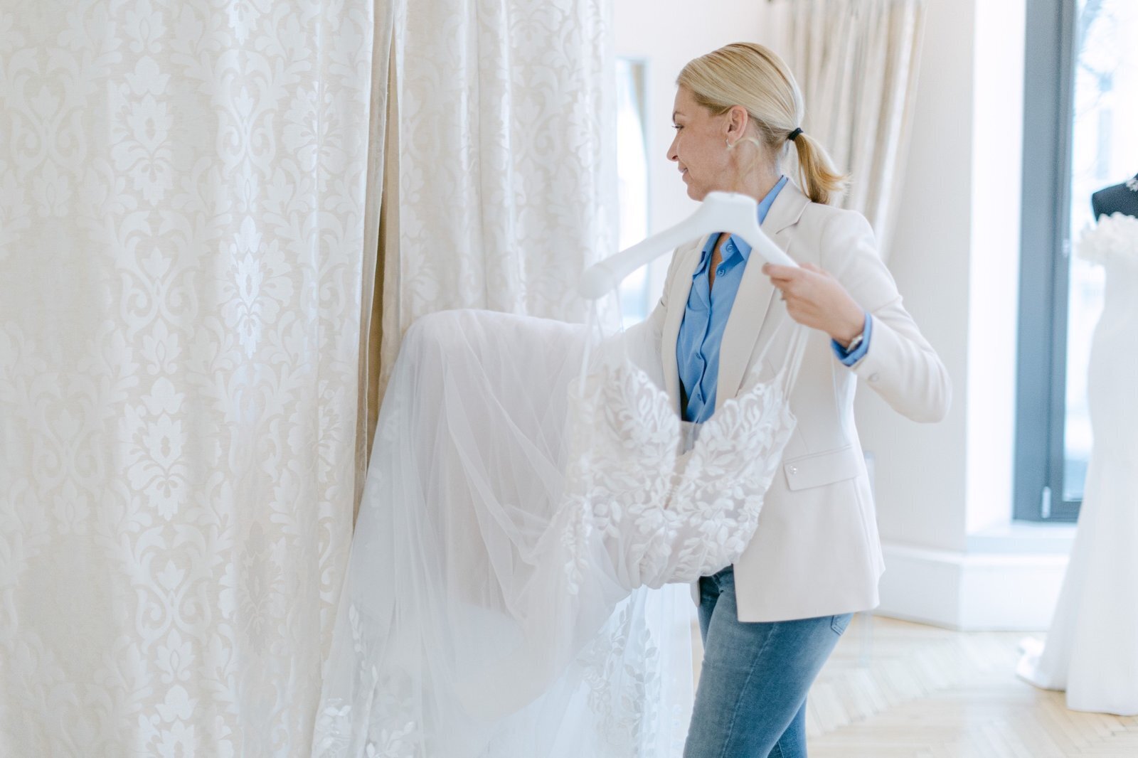 Luxury destination wedding planner assisting her bride at the bridal atelier in Vienna 