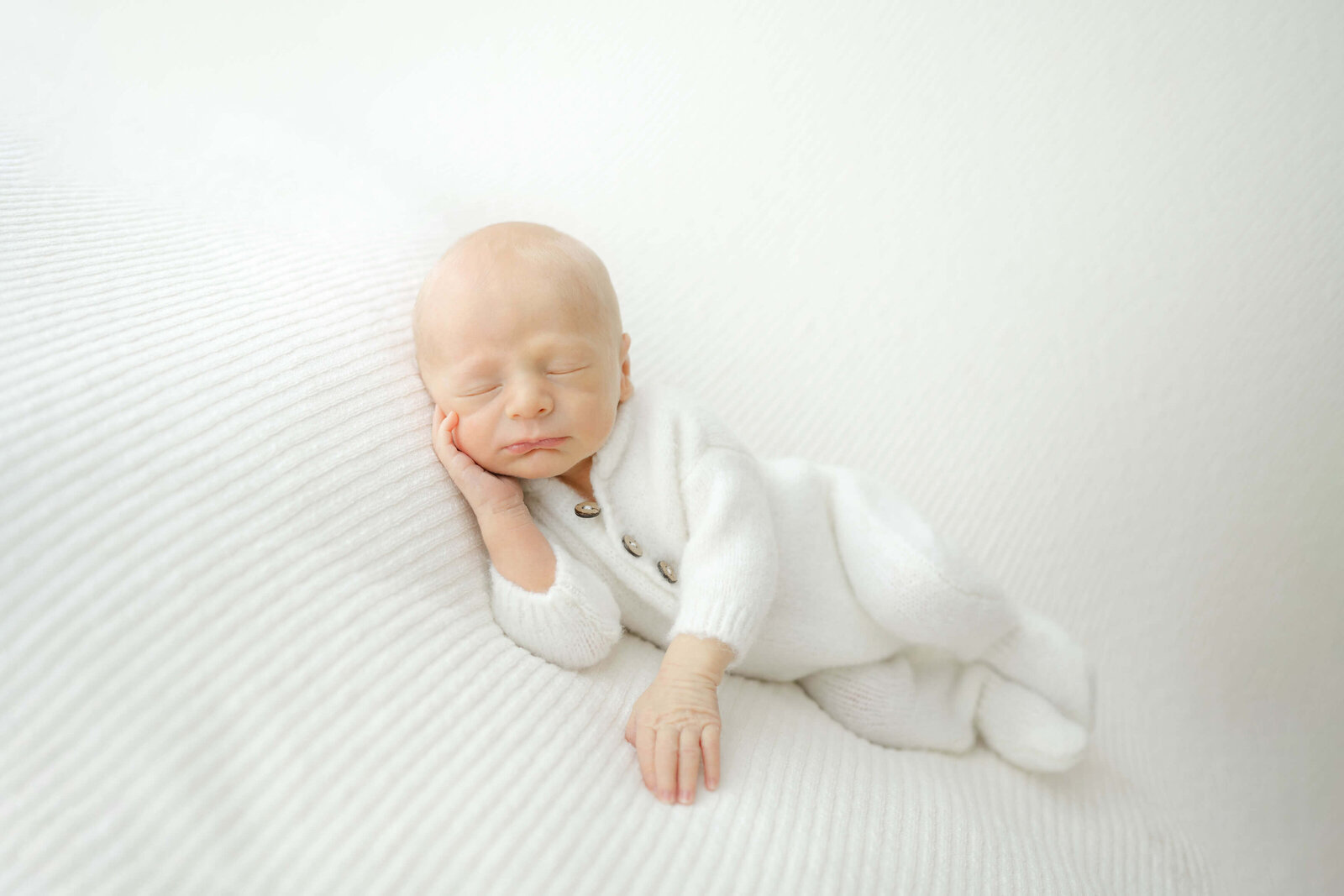 oklahoma city newborn sleeping in a white fuzzy outfit