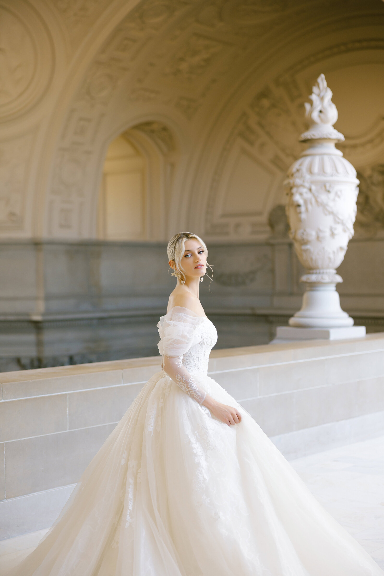 An elegant bride at San francisco city hall wth stunning wedding gown. Make up and hair styled by Yana Beauty Studio.