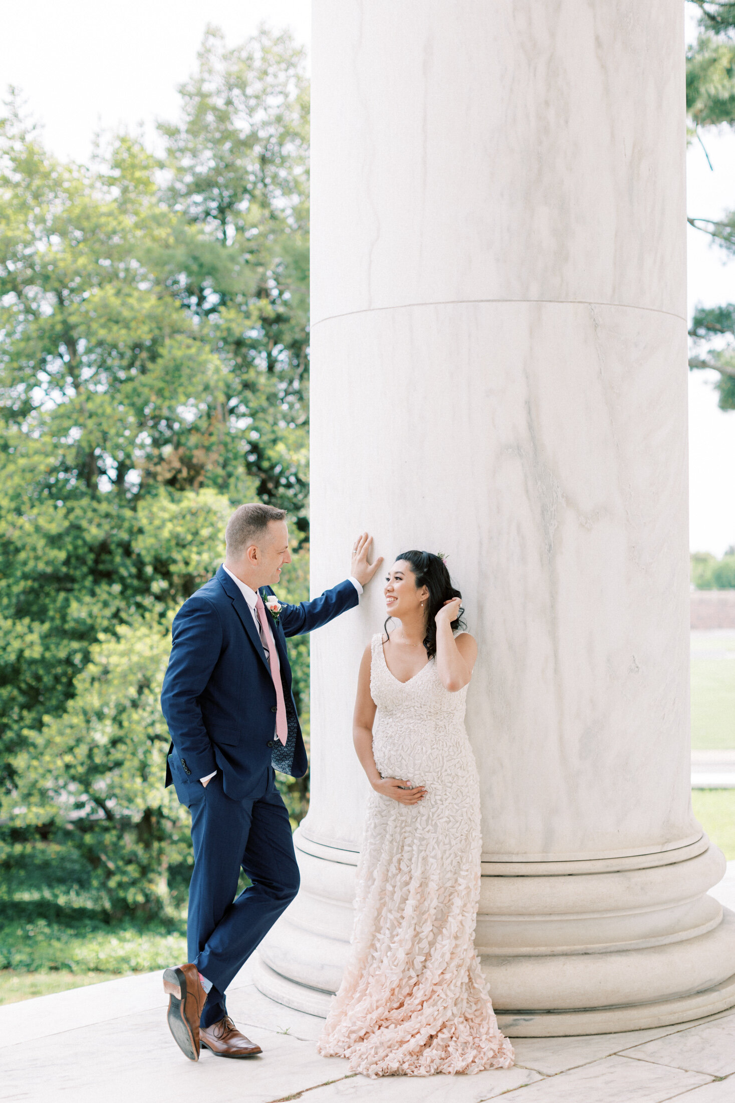 Bride leans against the Thomas Jefferson monument