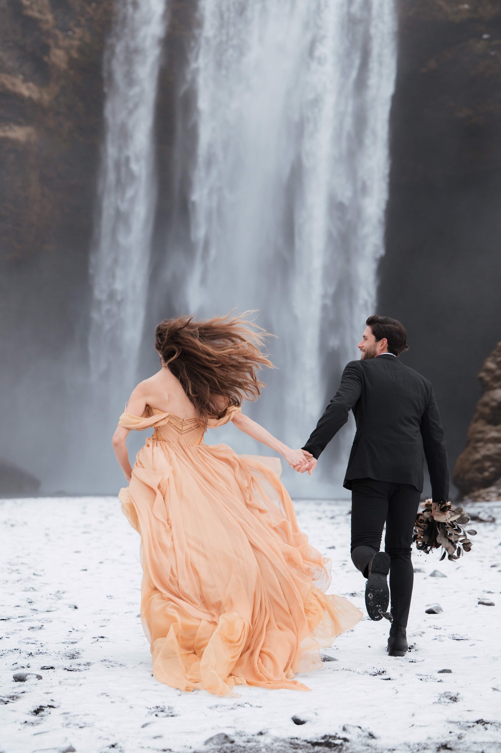 Adventure elopement in front of Skógafoss waterfall in Iceland