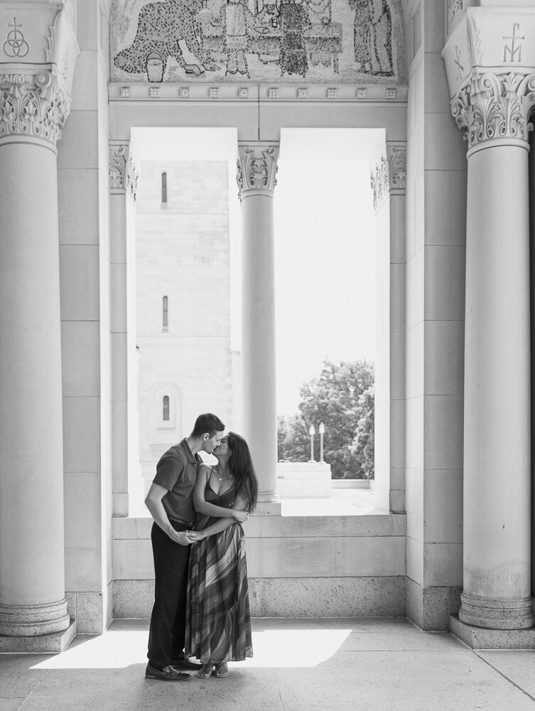 a catholic couple posing for engagement photos in a church