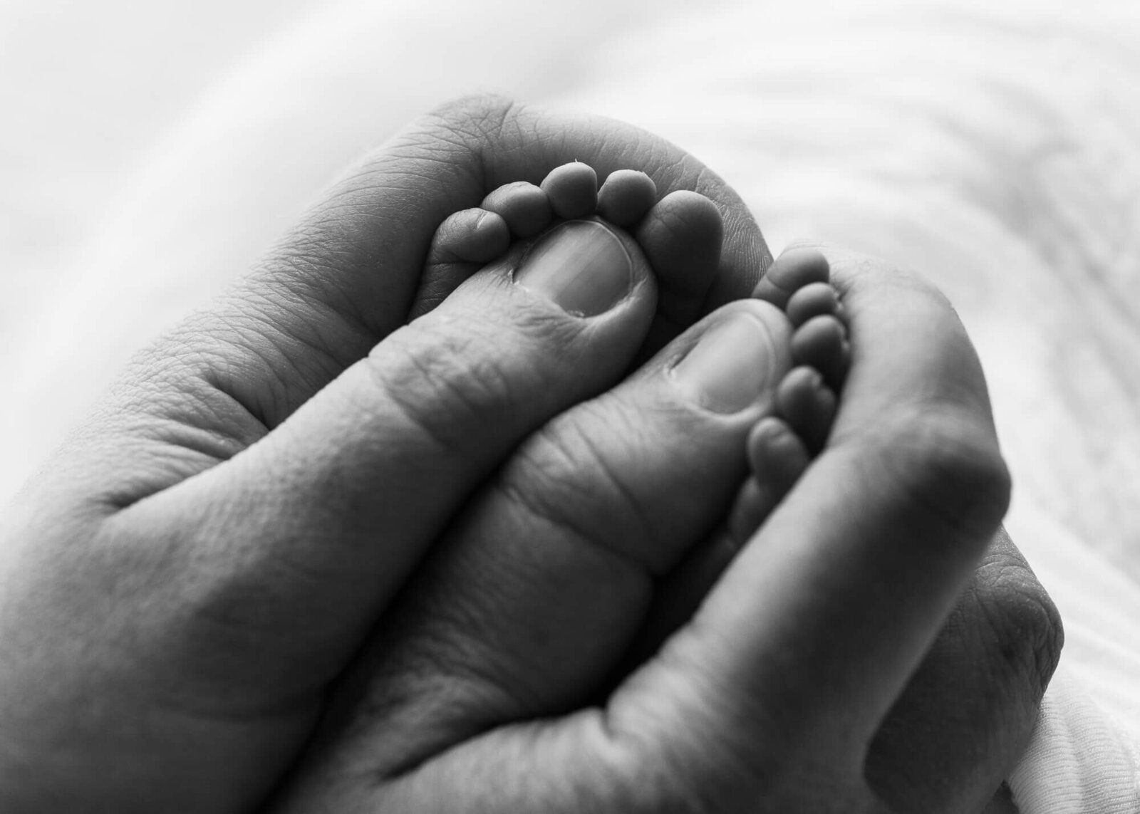 close up macro shot of mom holding baby's feet